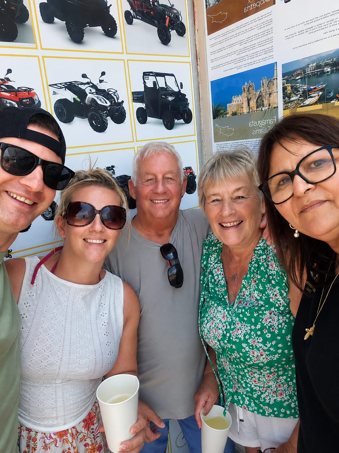 Five smiling customers ready for a tour outside the office